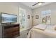 Main bedroom with TV, ceiling fan, and ensuite bathroom at 2809 Proust Ct, Henderson, NV 89044