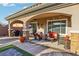 Inviting covered patio with stone pillars, comfortable seating, and stylish decor, perfect for outdoor relaxation at 2809 Proust Ct, Henderson, NV 89044