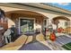 Covered patio featuring stone columns, an outdoor grill, and a comfortable seating area for enjoying the outdoors at 2809 Proust Ct, Henderson, NV 89044