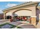 Inviting covered patio with comfortable seating, an outdoor kitchen, and stylish design, perfect for relaxing and entertaining at 2809 Proust Ct, Henderson, NV 89044