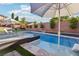 Outdoor pool area with lounge chairs and umbrellas, perfect for relaxation and enjoying the beautiful landscaped yard at 2809 Proust Ct, Henderson, NV 89044