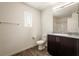 Modern bathroom features a granite countertop, white toilet, and a large mirror above the dark-wood vanity at 2813 Riverside Gold Ct, North Las Vegas, NV 89086