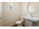 Powder room featuring a pedestal sink, modern faucet, and wood-look floors at 2813 Riverside Gold Ct, North Las Vegas, NV 89086