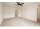 An empty bedroom features neutral carpet, a ceiling fan, and doorways to other rooms at 2813 Riverside Gold Ct, North Las Vegas, NV 89086