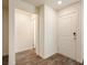 Bright entryway with wood-look flooring, white walls, and a view into the adjacent rooms at 2813 Riverside Gold Ct, North Las Vegas, NV 89086