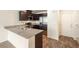 Updated kitchen boasts granite countertops, stainless steel appliances, and adjacent breakfast bar at 2813 Riverside Gold Ct, North Las Vegas, NV 89086