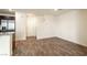 Spacious living area featuring a kitchen bar, staircase, and vinyl wood flooring at 2813 Riverside Gold Ct, North Las Vegas, NV 89086