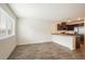 Spacious living area with wood-look flooring, large windows, and an open layout to the kitchen at 2813 Riverside Gold Ct, North Las Vegas, NV 89086