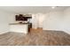 Open-concept living area with vinyl wood flooring, neutral paint, and staircase access at 2813 Riverside Gold Ct, North Las Vegas, NV 89086