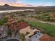 A residential area near a lake and golf course showcases houses with red tile roofs amidst lush greenery and hills at 3 Rue Allard Way, Henderson, NV 89011
