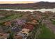 An exclusive community beside a lake features a golf course and custom homes with stunning mountain views at sunset at 3 Rue Allard Way, Henderson, NV 89011