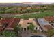A high angle shot captures a Southwestern-style home with a red tile roof nestled in a lush golf course community at 3 Rue Allard Way, Henderson, NV 89011
