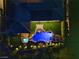 Aerial nighttime view of a backyard oasis featuring a pool, spa, and landscaped lighting at 3 Rue Allard Way, Henderson, NV 89011