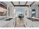 Gourmet kitchen with stainless steel appliances, white cabinets and countertops, and a breakfast nook with great natural light at 3 Rue Allard Way, Henderson, NV 89011
