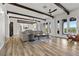 Open-concept living area with wood flooring, beamed ceilings, large windows and easy access to backyard at 3 Rue Allard Way, Henderson, NV 89011
