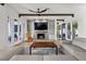Comfortable living room with fireplace, built-in shelving and access to multiple outdoor patios at 3 Rue Allard Way, Henderson, NV 89011