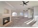 Open living space with a cozy fireplace, ceiling fan, and natural light creates an inviting atmosphere at 3408 Winterhaven St # 204, Las Vegas, NV 89108