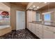 Bright bathroom features a dual sink vanity with granite countertops and a marble tile floor at 360 E Desert Inn Rd # 1903, Las Vegas, NV 89109