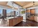 A modern kitchen with custom cabinetry, granite counters, island cooktop, and stainless steel appliances at 360 E Desert Inn Rd # 1903, Las Vegas, NV 89109