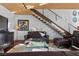 Bright living room with a staircase, dark wood floors, stylish furniture, and modern lighting fixtures at 360 E Desert Inn Rd # 1903, Las Vegas, NV 89109