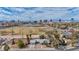 Aerial shot showcases a quaint neighborhood with a park, framed by the impressive Las Vegas skyline at 3731 Spencer St, Las Vegas, NV 89119