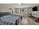Inviting bedroom with two beds, TV, and an abundance of natural light at 3731 Spencer St, Las Vegas, NV 89119