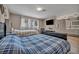 Cozy bedroom with two beds, TV, and attached bathroom featuring double sinks and modern finishes at 3731 Spencer St, Las Vegas, NV 89119
