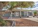Charming home with a large tree, gravel landscaping, and a covered walkway leading to the front door at 3731 Spencer St, Las Vegas, NV 89119