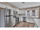 Modern kitchen featuring stainless steel appliances, white cabinets, and stylish backsplash at 3731 Spencer St, Las Vegas, NV 89119