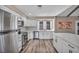 Updated kitchen features stainless steel appliances, white cabinetry and a large island at 3731 Spencer St, Las Vegas, NV 89119