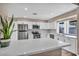 Bright kitchen with quartz countertops, stainless steel appliances, and eat-in bar at 3731 Spencer St, Las Vegas, NV 89119