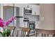 Updated eat-in kitchen features stainless steel appliances and white cabinetry at 3731 Spencer St, Las Vegas, NV 89119