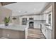 Eat-in kitchen with modern stainless steel appliances and white cabinetry at 3731 Spencer St, Las Vegas, NV 89119