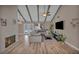 Stylish living room with vaulted ceilings, wood beams, and backyard view at 3731 Spencer St, Las Vegas, NV 89119
