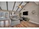 Open-concept living room with vaulted ceilings, wood beams, and a view of the backyard at 3731 Spencer St, Las Vegas, NV 89119