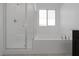 Clean bathroom design featuring glass enclosed shower, soaking tub, and a bright window at 3771 Bright Aquarius Ln, Henderson, NV 89052