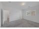 Bright bedroom boasts neutral carpet, white walls, and a window allowing natural light to illuminate the space at 3771 Bright Aquarius Ln, Henderson, NV 89052