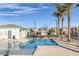 Community pool featuring tall palm trees with lounge chairs, tables and a bath house at 3771 Bright Aquarius Ln, Henderson, NV 89052