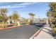 Community entrance gate surrounded by lush landscaping and views of beautiful homes at 3771 Bright Aquarius Ln, Henderson, NV 89052