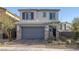 Charming two-story home featuring a two-car garage, desert landscaping, and stone accents at 3771 Bright Aquarius Ln, Henderson, NV 89052