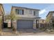 Charming two-story home with a two-car garage and desert landscaping in a suburban neighborhood at 3771 Bright Aquarius Ln, Henderson, NV 89052