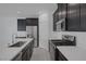 Bright kitchen with stainless steel appliances, an island and dark cabinets at 3771 Bright Aquarius Ln, Henderson, NV 89052