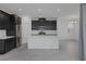Modern kitchen boasts black cabinets, white countertops, stainless appliances, and tile floors at 3771 Bright Aquarius Ln, Henderson, NV 89052