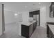Open concept kitchen with stainless steel appliances, an island and dark cabinets at 3771 Bright Aquarius Ln, Henderson, NV 89052