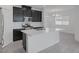 Modern kitchen with stainless steel appliances, a large island, and sleek black cabinetry at 3771 Bright Aquarius Ln, Henderson, NV 89052