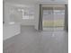 Bright living room with tile flooring and large sliding glass doors leading to the backyard at 3771 Bright Aquarius Ln, Henderson, NV 89052