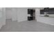 Spacious living room featuring tile flooring and views of the kitchen with stainless steel appliances at 3771 Bright Aquarius Ln, Henderson, NV 89052