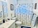 Bathroom featuring a single sink vanity, toilet, and a shower with a decorative curtain at 3856 Commanche Ave, Las Vegas, NV 89121