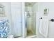 Bathroom featuring a shower with glass doors, tile floors, and white walls at 3856 Commanche Ave, Las Vegas, NV 89121