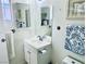 Bathroom features a single sink, two mirrors, and white tiled flooring at 3856 Commanche Ave, Las Vegas, NV 89121